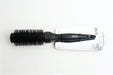 Black hairbrush with packaging on a white background