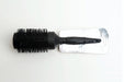 A black jumbo brush with a carbon-coated surface, displayed on a white background, packaged with a label.