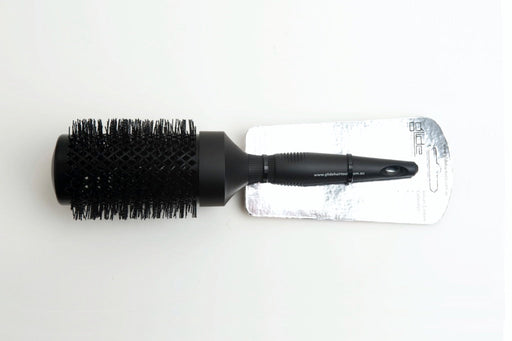 A black jumbo brush with a carbon-coated surface, displayed on a white background, packaged with a label.