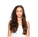 A woman shown from the shoulders up against a plain white background, with her hair split vertically down the middle to demonstrate a before-and-after style comparison. The left side shows curly, voluminous dark brown hair, and the right side shows smoother, straighter dark brown hair.