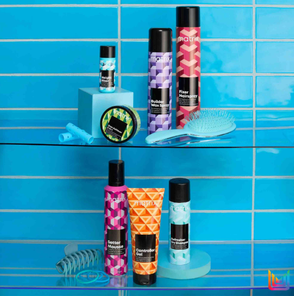 Collection of hair care products on a blue tiled shelf