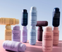 Collection of Nak Hair shampoo and conditioner bottles on a gradient background