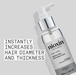 Nioxin hair serum bottle with text on a gray background
